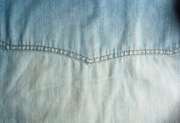 Blue washed faded jeans texture with seams