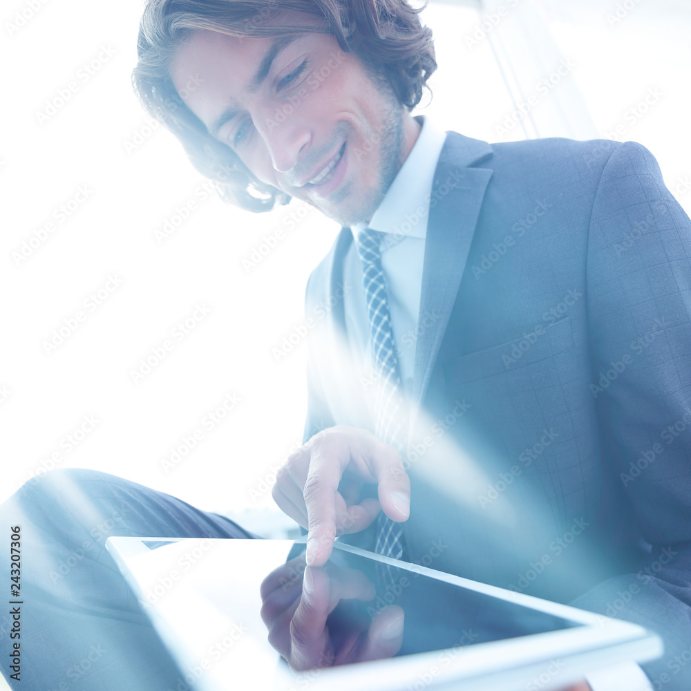 Wall mural portrait of successful businessman working on tablet computer.