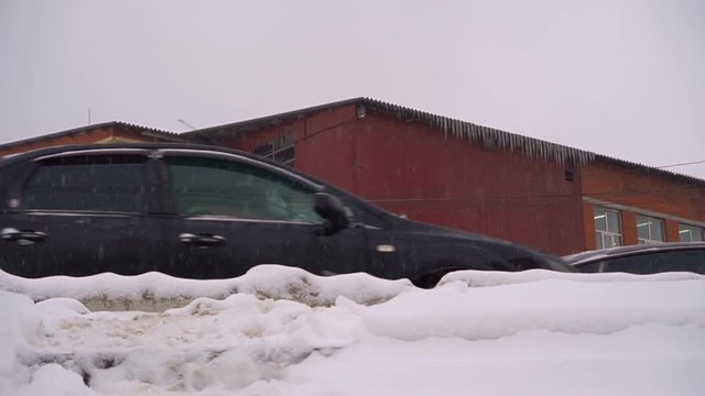 City Street. Cars Go On The Road. Winter Snowfall. Untreated Snow. Covered Sidewalks. Overcast Sky.