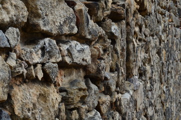 Wall made many old rocks construction