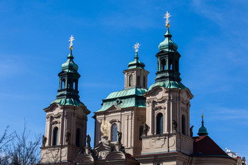 Fototapeta na wymiar Towers of the St. Nicolas Church located in Prague old town