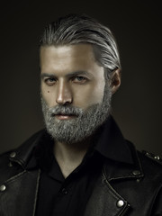 Portrait of tough old man in studio, shallow depth of field