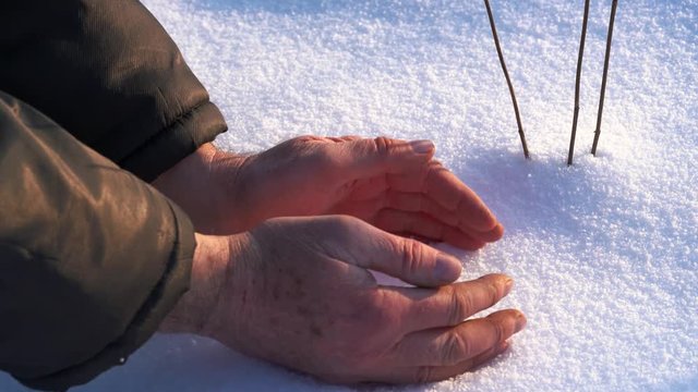Man make snowball with hands - (4K)