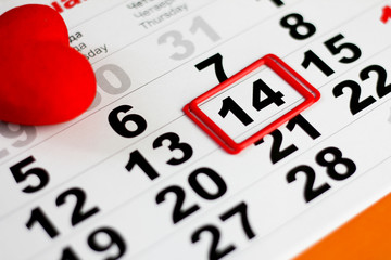 Calendar with red mark on 14 February. Red hearts decoration. Valentines day concept
