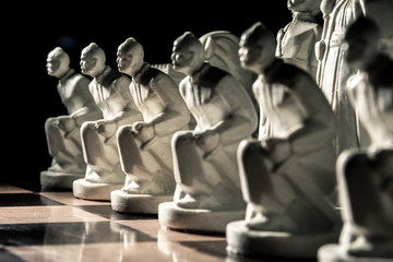Chess board. Beautiful white hand-made pawns among allied chess