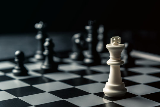 Chess board. White king threatens black opponent's chess