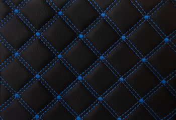 classic black leather Mat with straight blue stitching soft leather for machine with textured pattern concept background fabric business