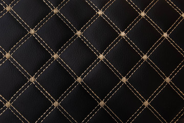 Fototapeta premium classic black leather Mat with straight beige stitching soft leather for machine with textured pattern concept background fabric business