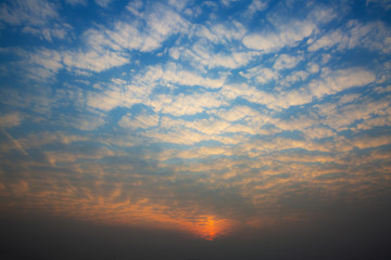 the sunset glows in the clouds