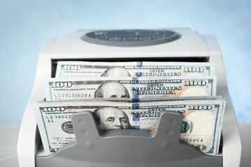 Modern bill counter with money, closeup view