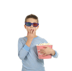 Fototapeta premium Emotional boy with 3D glasses and popcorn during cinema show on white background