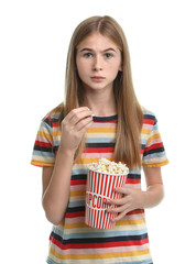 Emotional teenage girl with popcorn during cinema show on white background