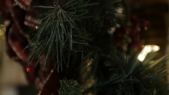 Close up shiny gold red Christmas bow and garland