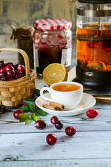 Hot spicy lingonberry or cranberry tea in cup, rustic background