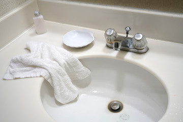 close up on old sink in bathroom with towel