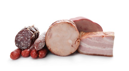 Different tasty meat delicacies on white background