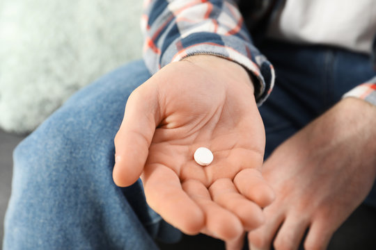 Man holding pill in hand, closeup view. Health care