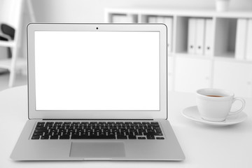 Fototapeta premium Comfortable workplace with modern laptop on table in office. Mockup for design