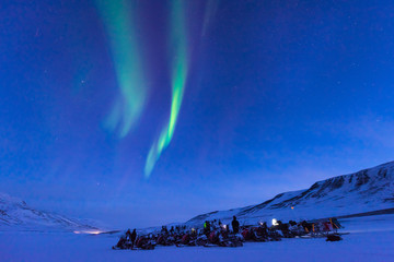 The polar arctic Northern lights aurora borealis sky star in Norway Svalbard in Longyearbyen the snowmobile mountains