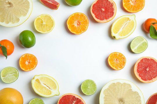 Different citrus fruits on white background, flat lay. Space for text