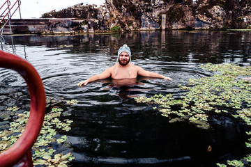 Man going to Swim in Lake in a cold Winter day
