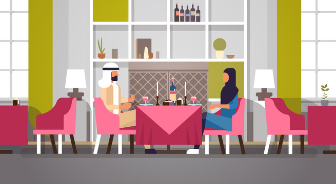 arabic couple sitting cafe table romantic dinner happy valentines day celebration concept arabic man woman love dating modern restaurant interior horizontal flat