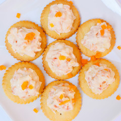 Tasty crackers with cream cheese,carrot.Healthy snacks, on dish