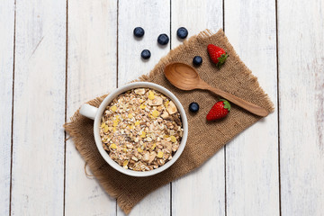 homemade Granola,yogurt and fresh blueberry with Strawberry In the cup on wooden background