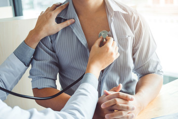 Obraz na płótnie Canvas Doctor Measuring arterial blood pressure man patient Health care in hospital