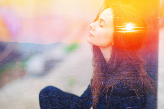 Double multiply exposure portrait of a dreamy cute woman meditating outdoors with eyes closed, combined photograph of nature, sunrise or sunset. closeup. Psychology power of mind inner voice concept.