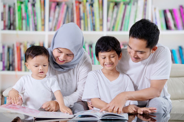 Asian family reading books in the library