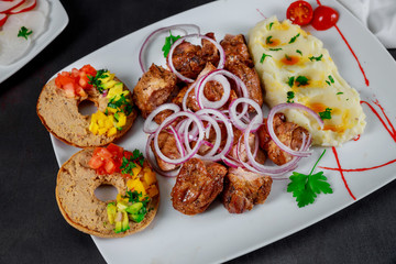 Roasted grilled skewers pork meat with mashed potatoes in plate on table