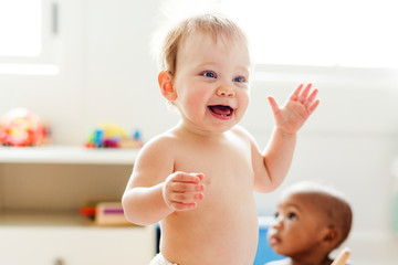 Cheerful baby balancing while standing