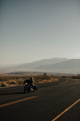 Man riding a motorcycle on a scenic route in USA