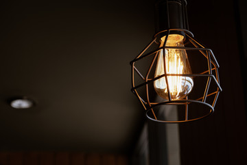 Beautiful vintage luxury light lamp hanging decor glowing in dark. Retro filter effect style.