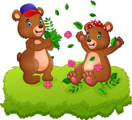 Cute couple of teddy bears playing with fallen leaves