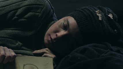 Homeless woman holding Help sign, social charity programs for low income people