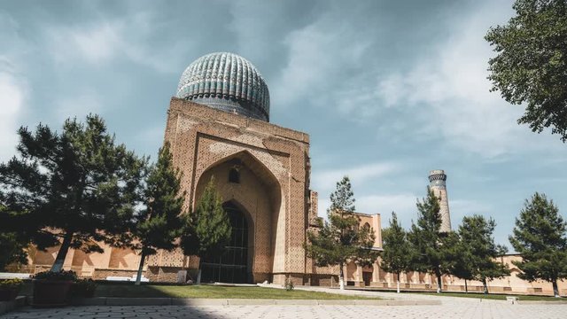 4k Timelapse movie film clip of of Bibi-Khanym Mosque complex with the beautiful bright blue domes, rich mosaic decorations and old hieroglyphs on its walls, Samarkand, Uzbekistan.