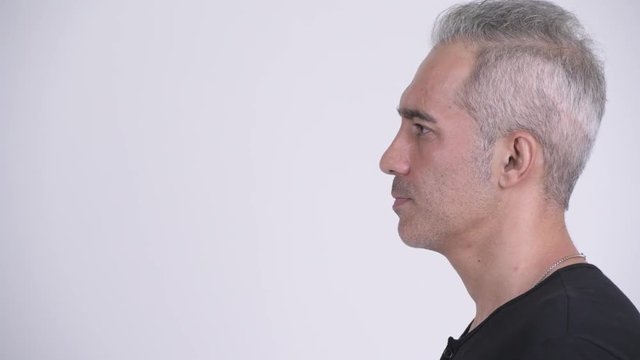 Profile view of handsome Persian man against white background