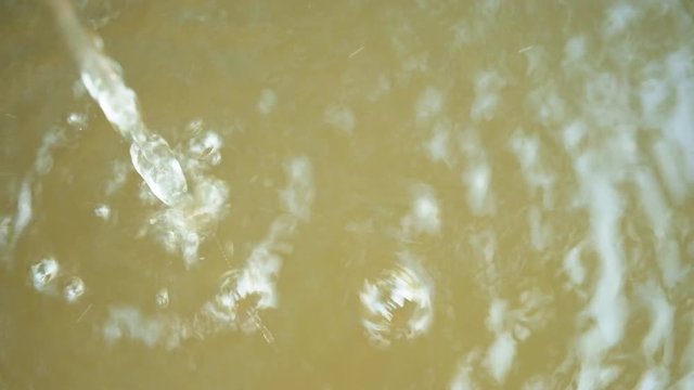 top view of water falling to the river and make lot of small pattern wave in 4k resolution 29.97 frames per second no sound