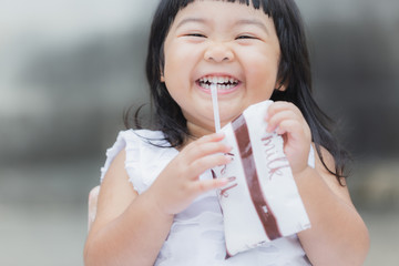 Adorable girl smiling and drink a milk for healthy.