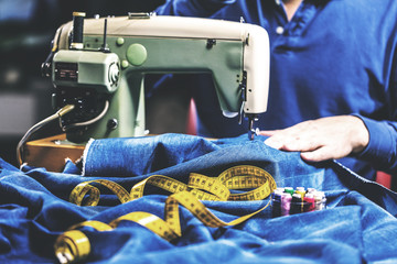 Sewing denim jeans with sewing machine. Repair jeans by sewing machine. Alteration jeans, hemming a...