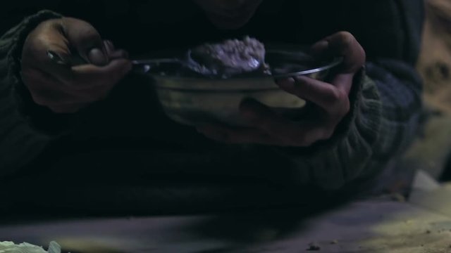 Volunteer giving food to homeless man, humanitarian assistance, charity program