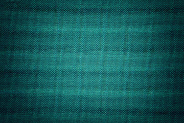 Fototapeta premium Turquoise background from a textile material with wicker pattern, closeup.