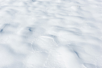 Large snowdrifts on a snowy field