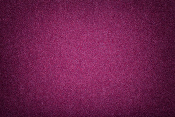 Dark purple matt suede fabric closeup. Velvet texture of felt.