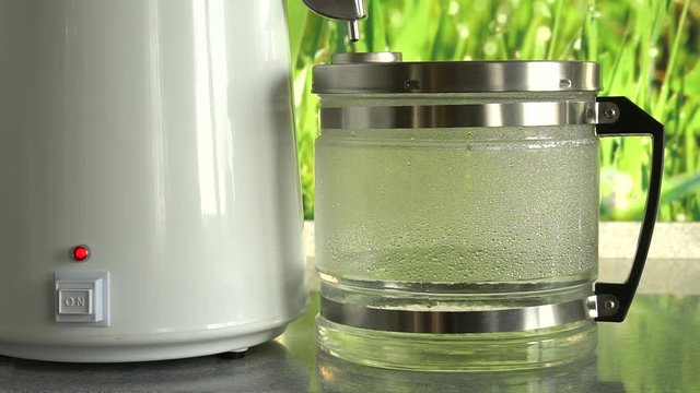 Production of clean water or alcohol. Table home or chemical laboratory Distiller for production of pure water. Process of cleaning fluid. Alcohol mashine. Close up