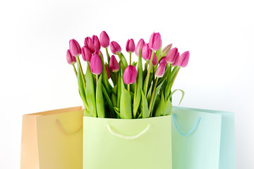 Fresh bright bouquet of pink tulip in paper bags. Beautiful greeting card. Spring holidas concept.