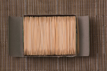 box of bamboo toothpicks on a table set for dental care teeth cleaning