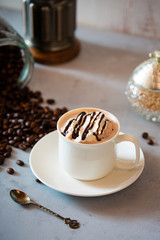 cup of coffee with whipped cream and beans